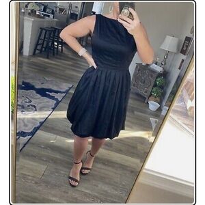 Pleated Maggy London, black, bubble hem dress with pockets and scooped back.